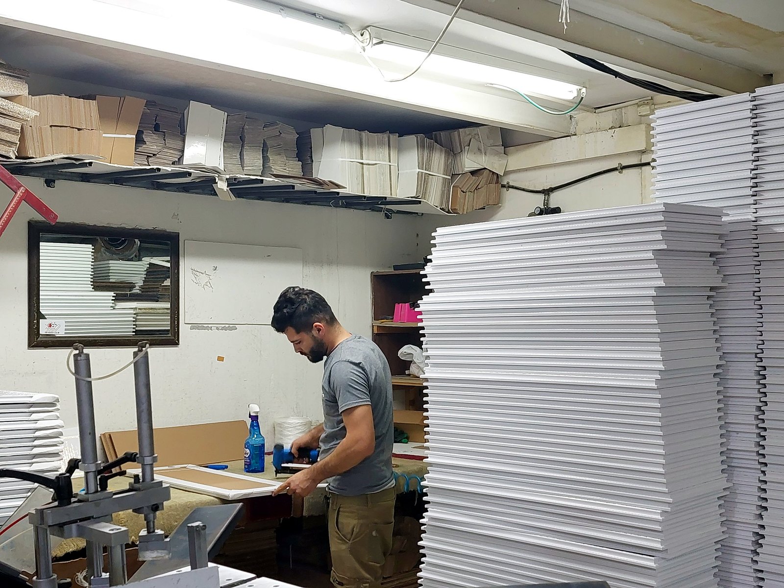 Artisan framing Scripture gifts in our Holy Land workshop